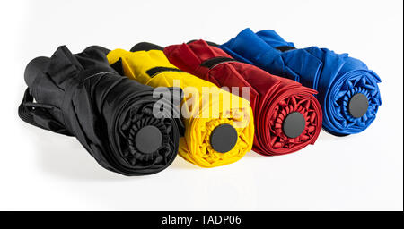 Multicolored compact umbrellas isolated on white Stock Photo