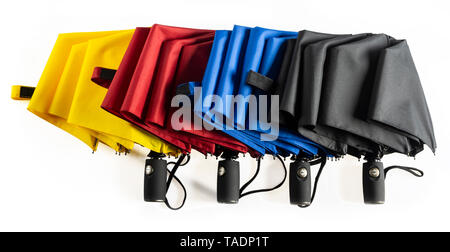Multicolored unfolded compact umbrellas isolated on white Stock Photo