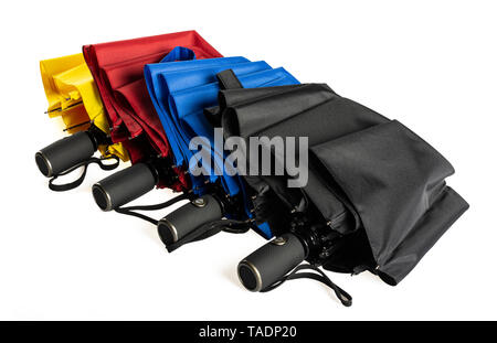 Multicolored unfolded compact umbrellas isolated on white Stock Photo
