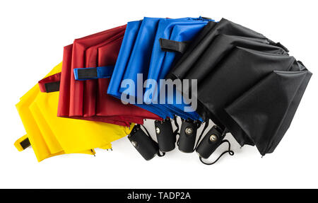 Multicolored unfolded compact umbrellas isolated on white Stock Photo