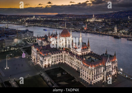 Budapest, Hungary - Aerial view of the beautiful illuminated Parliament of Hungary at dusk with Szechenyi Chain Bridge, Fisherman's Bastion and other 