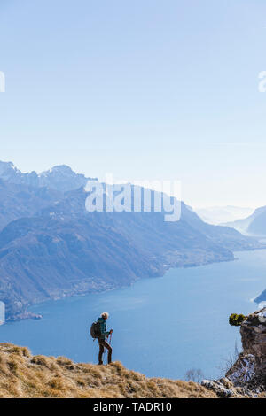 Italy, Como, Lecco, woman on a hiking trip in the mountains above Lake Como Stock Photo