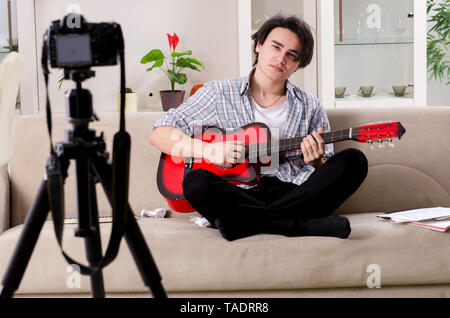 Young guitar player recording video for his blog Stock Photo