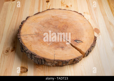 Round slab of wood lying on planks Stock Photo