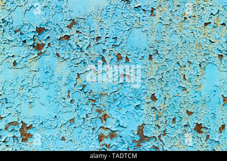 Rusty metal surface painted with peeling blue paint. Stock Photo