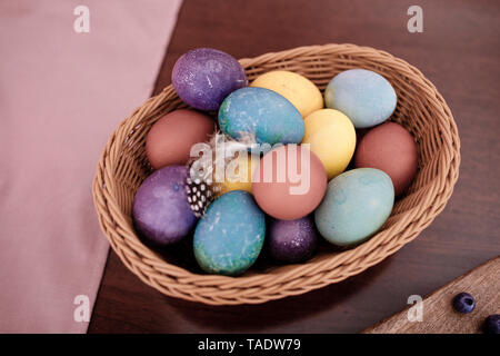 Dyed Easter eggs in a basket Stock Photo