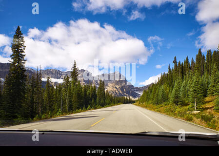 Canada, Alberta, Jasper National Park, Banff National Park, Icefields Parkway, road and landscape seen through windscreen Stock Photo