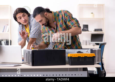 IT engineers working on hardware issue Stock Photo