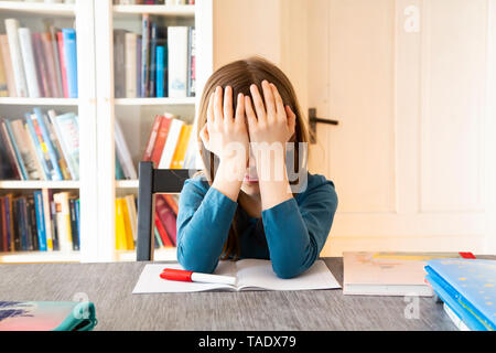Frustrated girl with homework Stock Photo