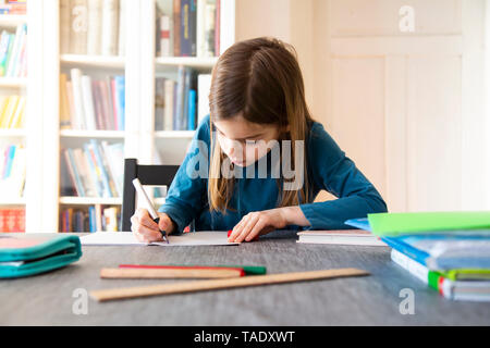 Caucasian girl doing homework in domestic kitchen Stock Photo - Alamy