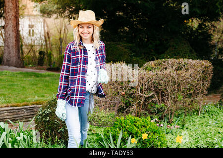 Young woman gardening, basket Stock Photo