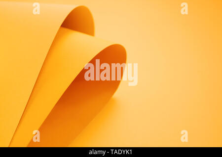 Orange folded papers as background Stock Photo