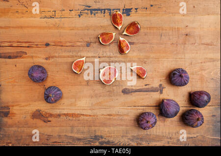 Kitchen knife and whole and sliced figs on wood Stock Photo