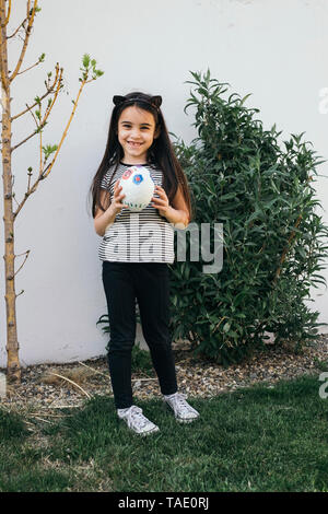 Portrait of a cute girl painted in the colors of Holi festival Stock Photo  - Alamy