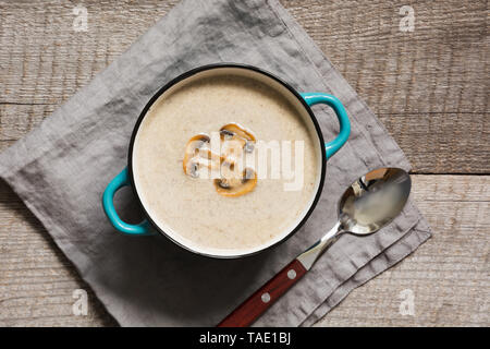 Delicious mushroom champignon soup on wooden board. Horizontal mockup, view from above. Stock Photo