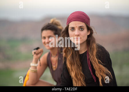 Two beautiful hippie girls at sunset Stock Photo