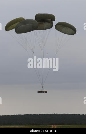 Members of the 82nd Airborne Division, Fort Bragg, NC, hook up their static  lines to the anchor cable on a US Air Force C-130 Hercules prior to their  parachute jump. The paratroopers