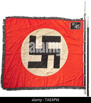 An SS Sturm flag of III./45 in Rosenberg/Upper Silesia complete with pole and finial Red flag cloth with black-silver fringe on three sides, both sides with a stitched-in white disc and a slanted swastika with black surfaces trimmed in silver cord. Silver embroidered 'III/45' for the 3rd Sturmbann (Rosenberg O.S) of 45th SS Foot Standarte (Neisse O.S.). Seven directly stitched-on nickel-plated standard rings. Supply stamping, small blemishes. Dimensions ca. 120 x 145 cm. Two-piece black wooden flagstaff. Nickel-plated finial in the form of a lance tip, punched 'RZM M3/39/40, Editorial-Use-Only Stock Photo