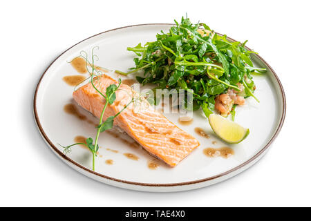 Steamed salmon with arugula and shrimps garnish Stock Photo