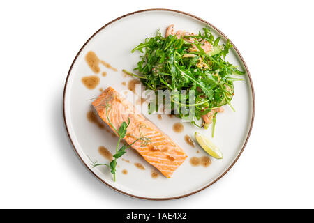 Steamed salmon with arugula and shrimps garnish Stock Photo