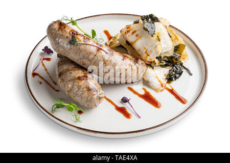 Fried Weisswurst (white veal sausage) with marinated cabbage and sea wed Stock Photo