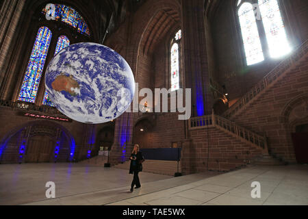 Gaia, a 23ft replica of planet earth hangs on display inside Liverpool Cathedral ahead of the city's River festival. The large installation, created by British artist Luke Jerram, features accurate and detailed imagery from NASA and is on display for the first time anywhere in the world. Stock Photo