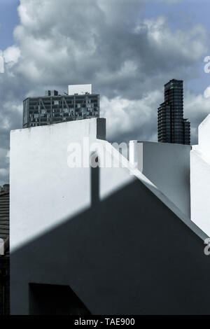 Mixing of forms and shapes, layering in modern architecture - part of stairs and facade building, unusual geometrical exterior game of light. Stock Photo