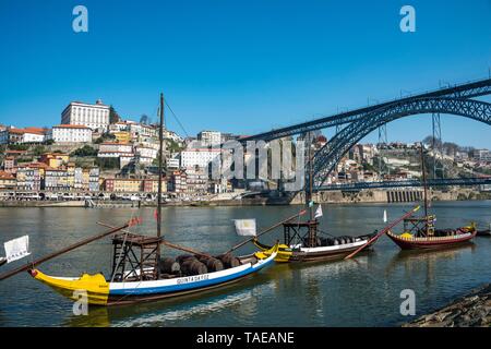 Rabelo boats, port wine boats on the river Rio Douro, behind bridge Ponte Dom Luis I, Porto, Portugal Stock Photo