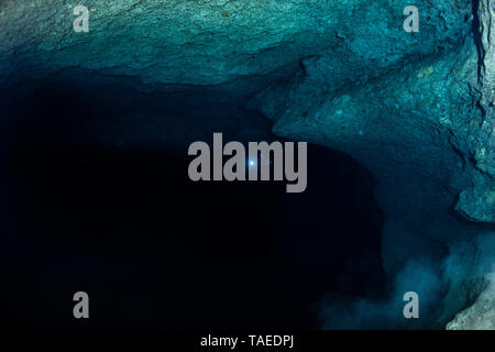Alone in the dark cave, Mayotte. The diver gives the scale of the cavity. Stock Photo
