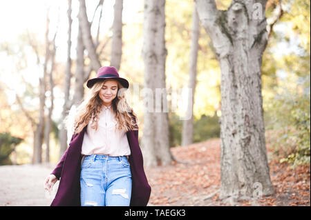 Smiling stylish teen girl 15-16 year old walking in park closeup. Autumn season. Teenagerhood. Stock Photo