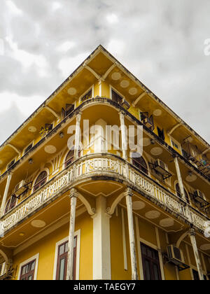 MACAU,CHINA - NOVEMBER 2018: Old yellow residential building in the city center with Portuguese and Macanese features Stock Photo