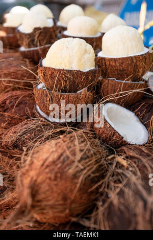 Vertical close up view of fresh young coconuts for sale in India. Stock Photo