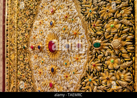 Horizontal close up view of a gold embroidered wall hanging in India. Stock Photo