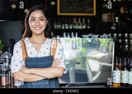 Asian women Barista smiling and using coffee machine in coffee shop counter - Working woman small business owner food and drink cafe concept Stock Photo