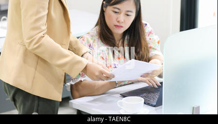Asian businesswoman serious about the work and using notebook for business partners discussing documents and ideas at meeting Stock Photo