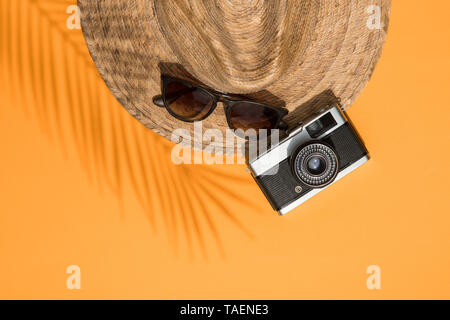 Summer vacation accessories, hat, sunglasses and camera lay flt composition Stock Photo