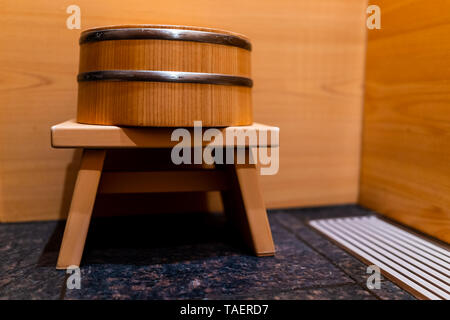 Cypress bathtub wooden traditional Japanese tub with water stool in home house or onsen hotel bathroom interior with nobody and in Japan Stock Photo