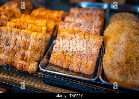 Closeup of many dessert pastries with sugar on shelf tray display desserts in bakery shop cafe store counter in Takayama, Gifu Prefecture in Japan Stock Photo