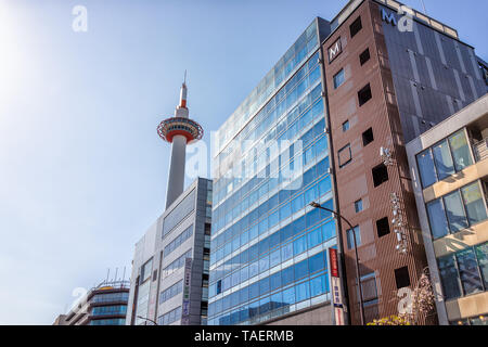Kyoto, Japan - April 9, 2019: Skyline cityscape during day of big city with tower near station with sunny sky looking up Stock Photo