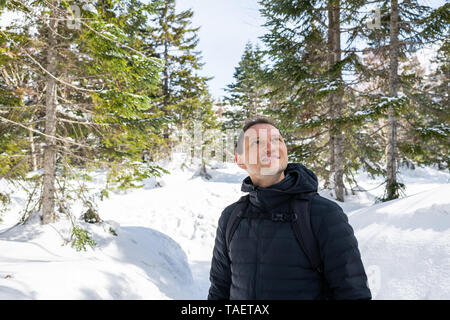 Young happy smiling man on mountain trail with snow in Okuhida villages Shinhotaka Ropeway in Gifu Prefecture, Japan park on spring day Stock Photo