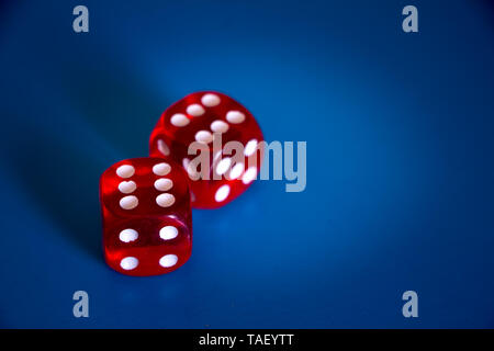 Close-up of two red dices with sixes on the top on a blue background, winning concept Stock Photo