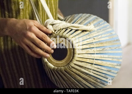 Closeup of hands on indian drum, musical accompaniment in yoga studio, selective focus Stock Photo