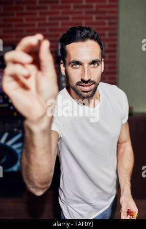 Portrait of man playing darts Stock Photo