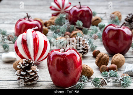 Christmas apples, walnuts, hazelnuts and Christmas decoration on wood Stock Photo