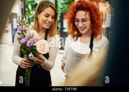 Two florists arranging flowers in flower shop Stock Photo