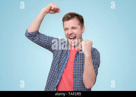 man looking so excited putting his fist up Stock Photo