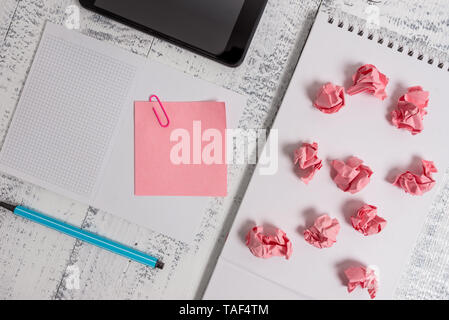Squared spiral notebook marker smartphone paper balls note clip wooden Stock Photo