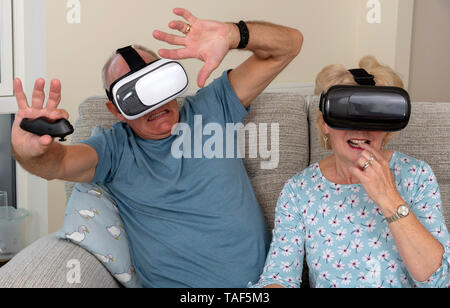 Portsmouth UK, Elderly couple having fun wearing virtual reality goggles Stock Photo