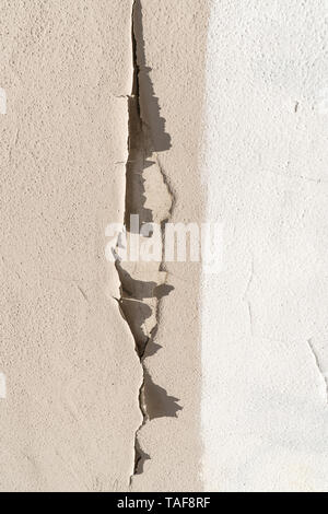 White and beige Painted wall with peeling paint. Abstract background Stock Photo