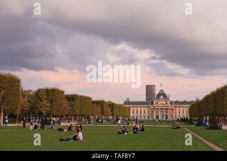 The Ecole Militaire with Parisians enjoying lawn in Park,  Paris, France Stock Photo